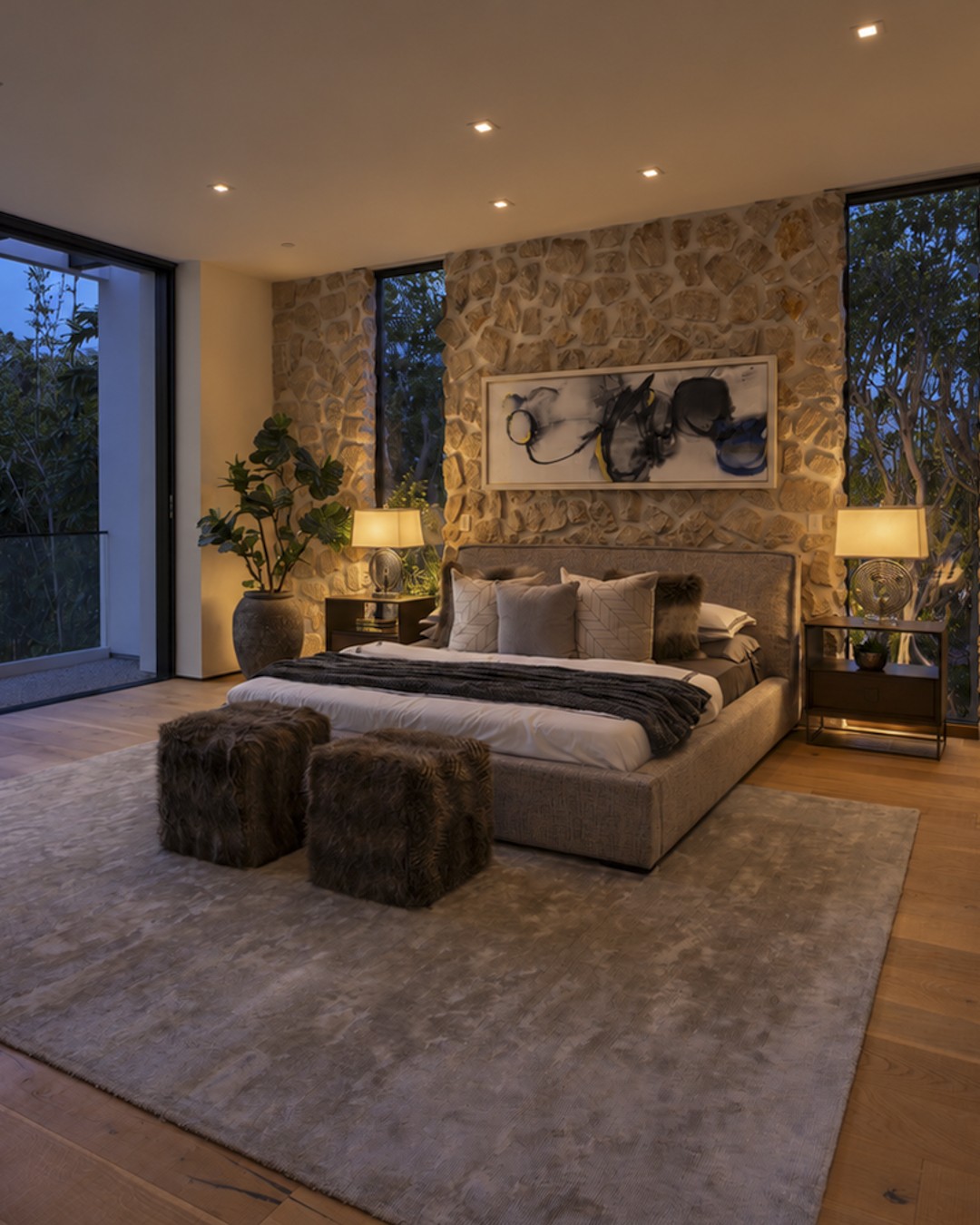Stone-walled bedroom with warm evening lighting